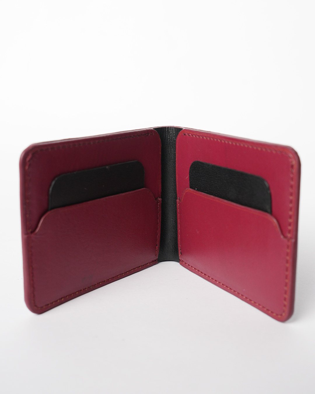Black and oxblood two-tone bifold wallet, open